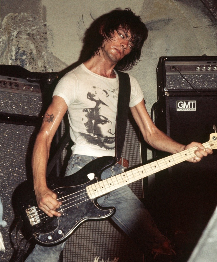A sweaty Dee Dee Ramone playing bass.