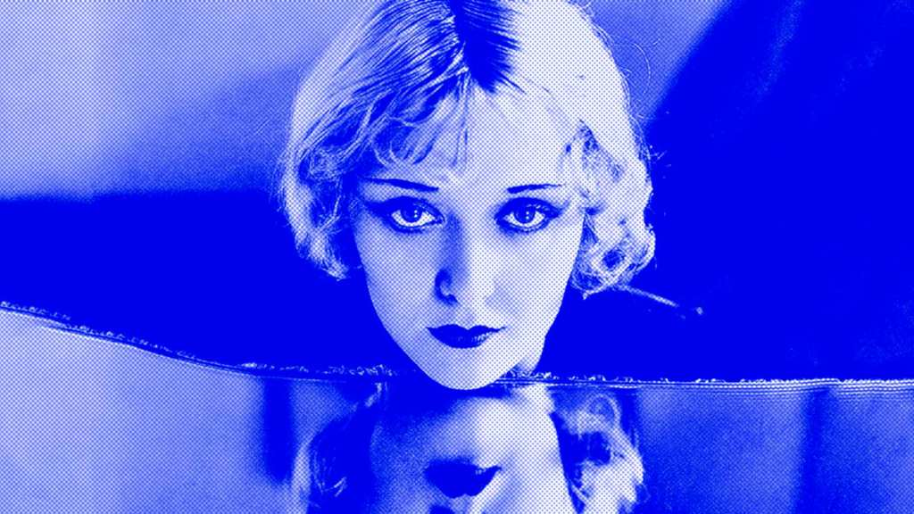 Showgirl and actress Mary Nolan, looking at her reflection in a mirror.