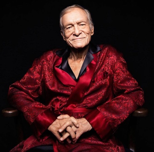 Hugh Hefner wearing a burgundy smoking jacket