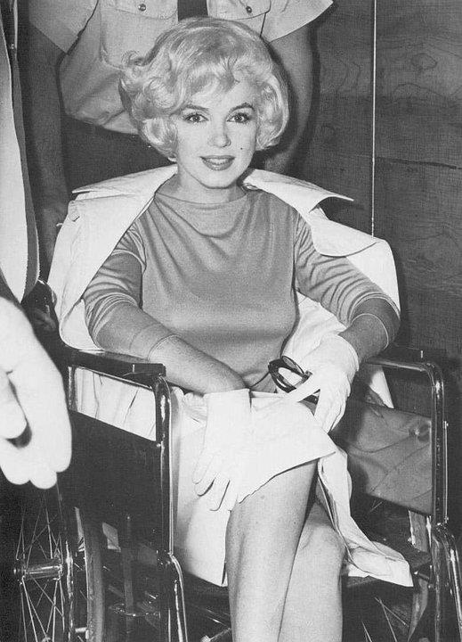 Marilyn Monroe leaving hospital in a wheelchair, 1961.